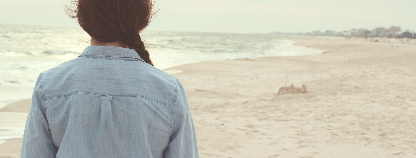 woman walking at beach feeling pressured by other people