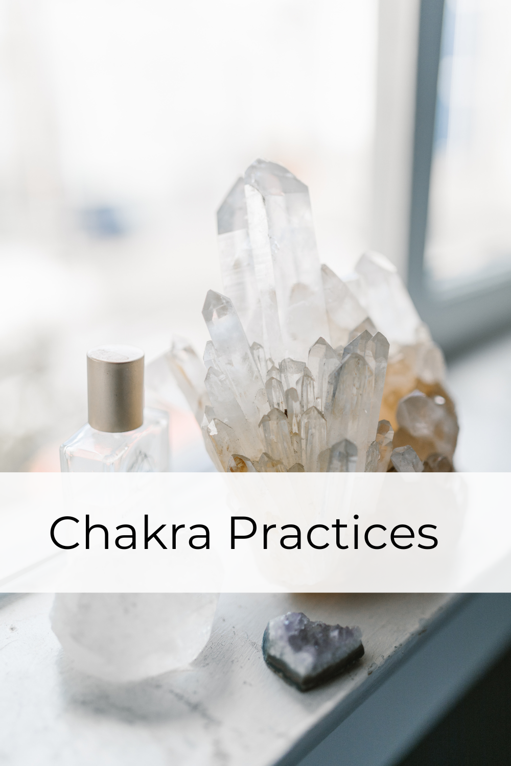 clear quartz crystal cluster sitting on the window ledge beside a bottle