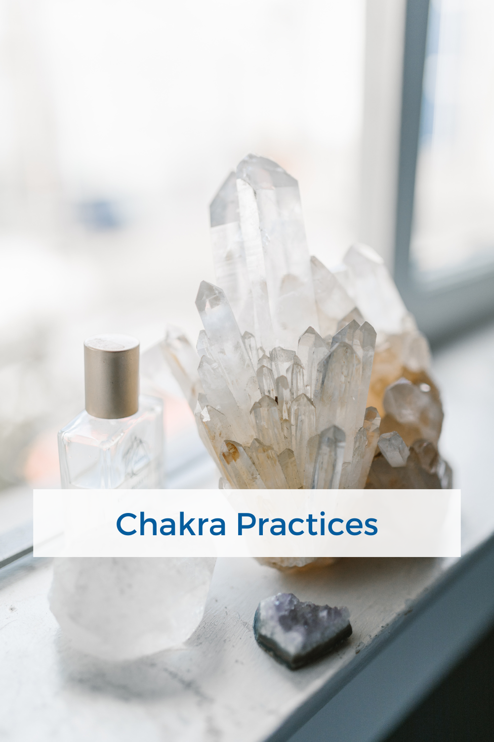 clear quartz crystal cluster sitting on the window ledge beside a bottle