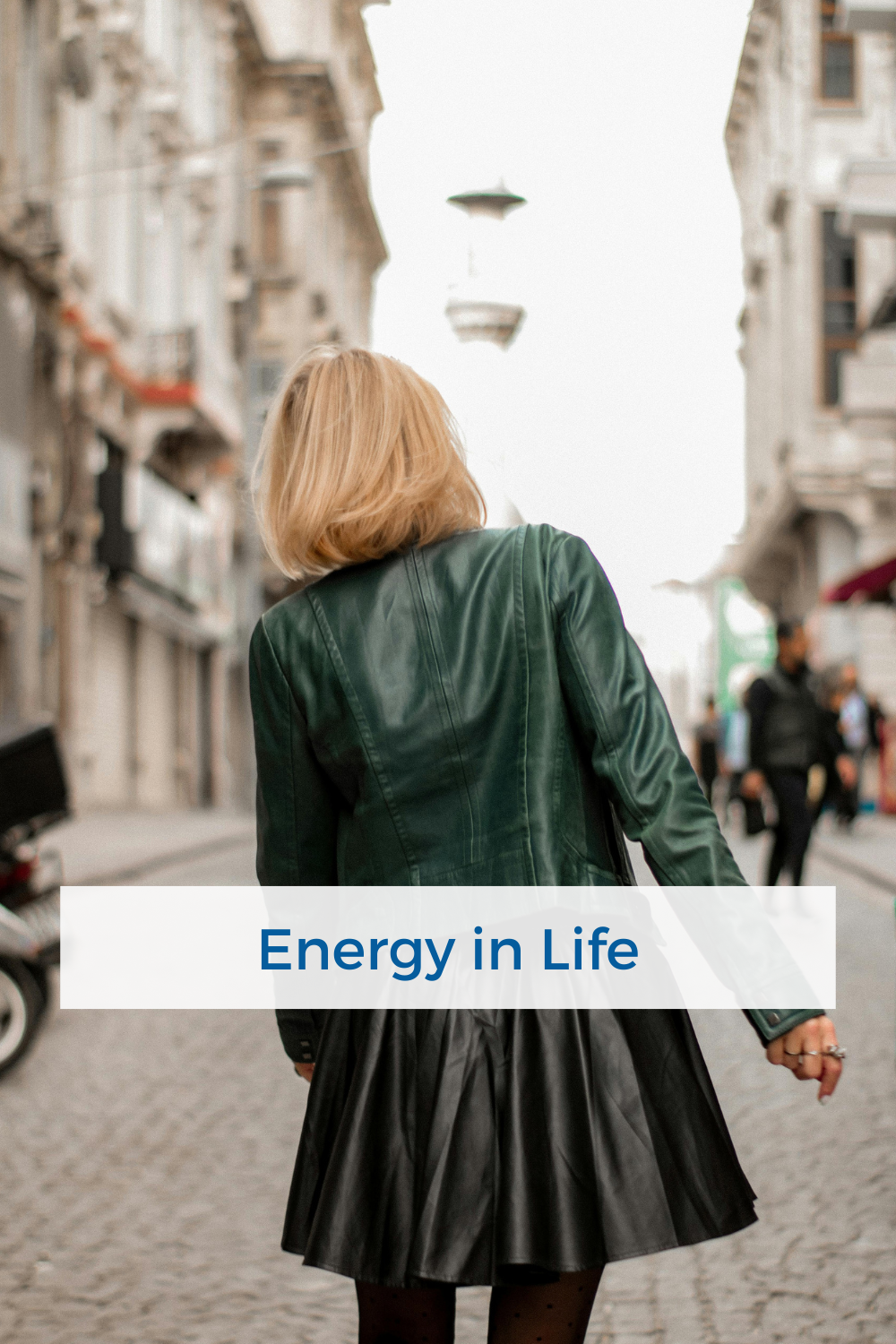 woman walking about her day with people and buildings around her