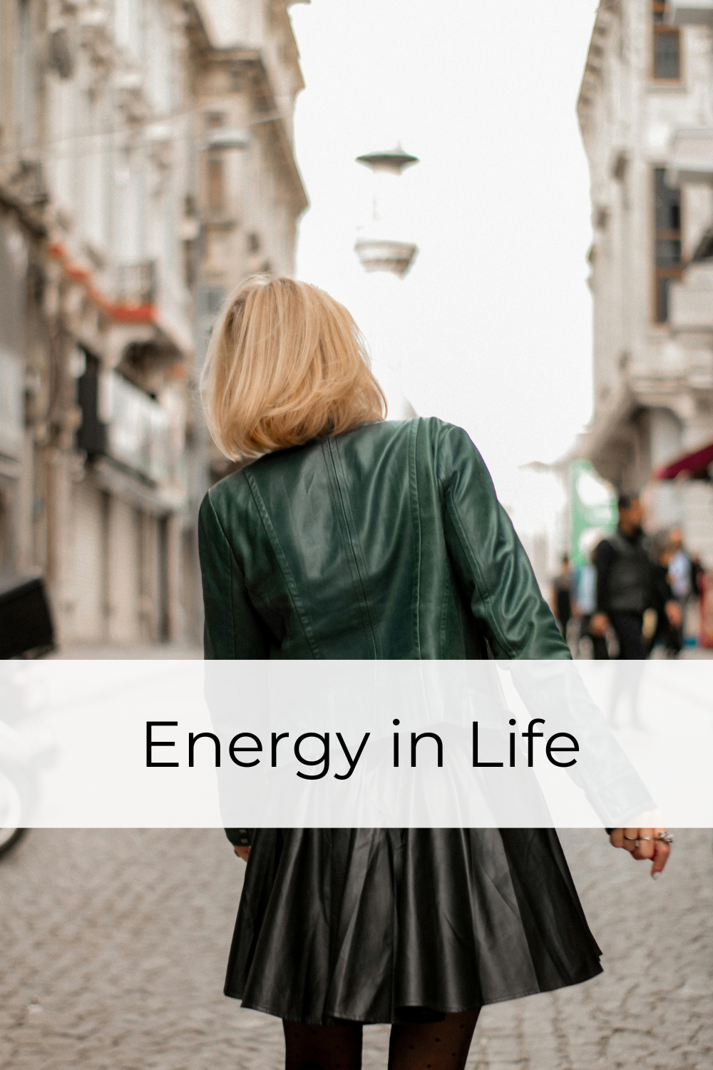woman walking about her day with people and buildings around her