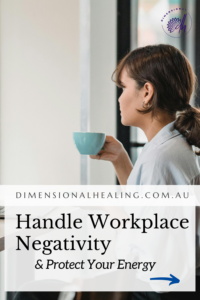 young woman sitting at her laptop drinking from a teacup worrying about the energy in her workplace